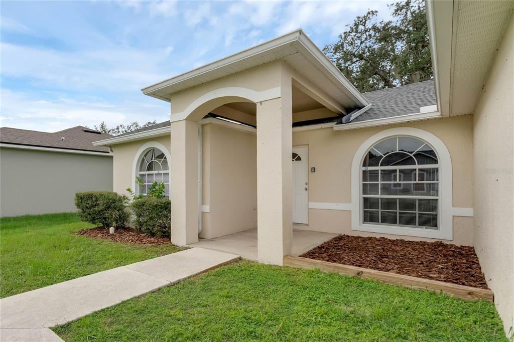 339 Erie Drive Poinciana, FL 34759 - Photo 1 of 15 a front view of a house with a yard