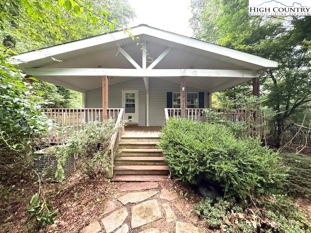a view of a house with garden and porch
