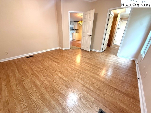 1269 Howell Road Lansing, NC 28643 - Photo 11 of 34 a view of empty room with wooden floor and window