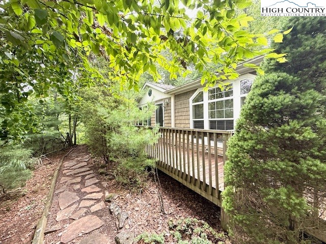 1269 Howell Road Lansing, NC 28643 - Photo 2 of 34 a porch with a tree in the background