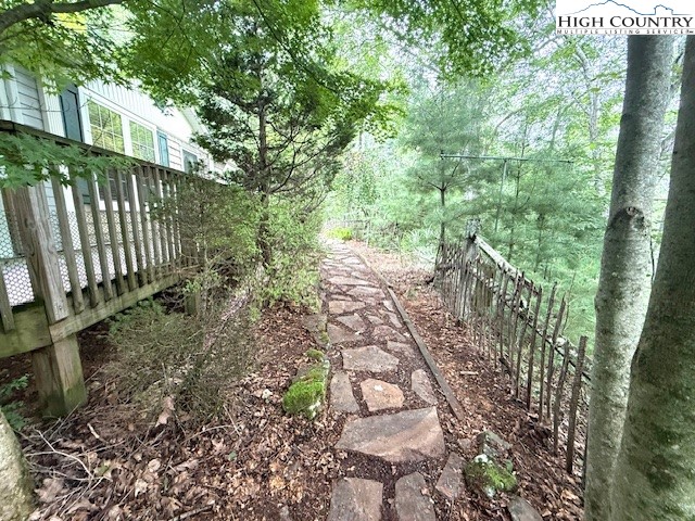 1269 Howell Road Lansing, NC 28643 - Photo 28 of 34 a view of a yard with plants and wooden fence
