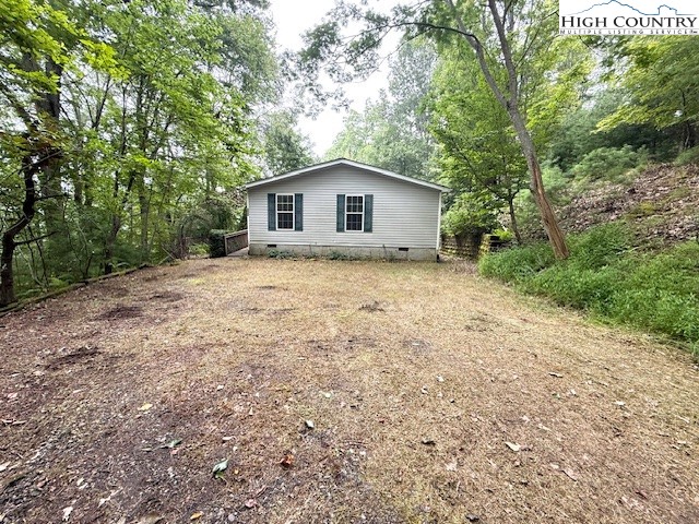 1269 Howell Road Lansing, NC 28643 - Photo 30 of 34 a dirt road with a house in the background