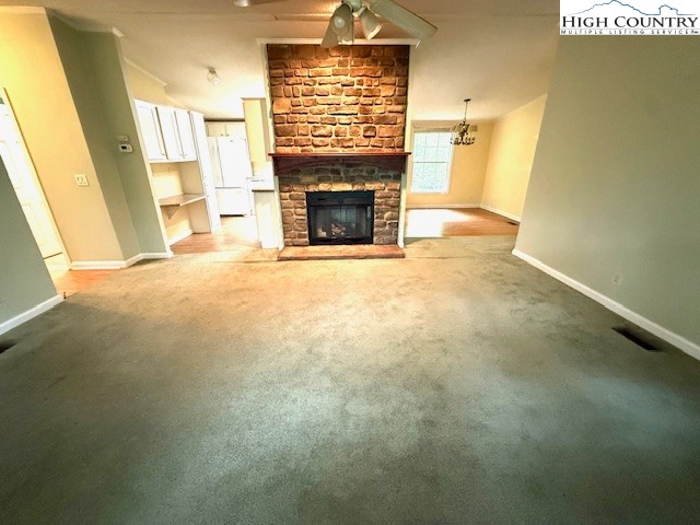 1269 Howell Road Lansing, NC 28643 - Photo 3 of 34 a view of an empty room with a fireplace and a window