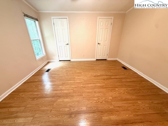 1269 Howell Road Lansing, NC 28643 - Photo 9 of 34 a view of an empty room with wooden floor