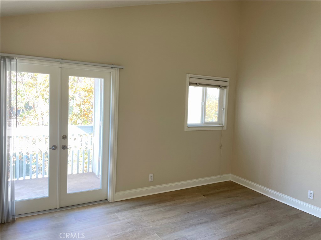 34006 Selva Road Dana Point, CA 92629 - Photo 13 of 16 an empty room with wooden floor and windows