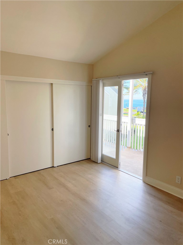 34006 Selva Road Dana Point, CA 92629 - Photo 14 of 16 an empty room with wooden floor and windows