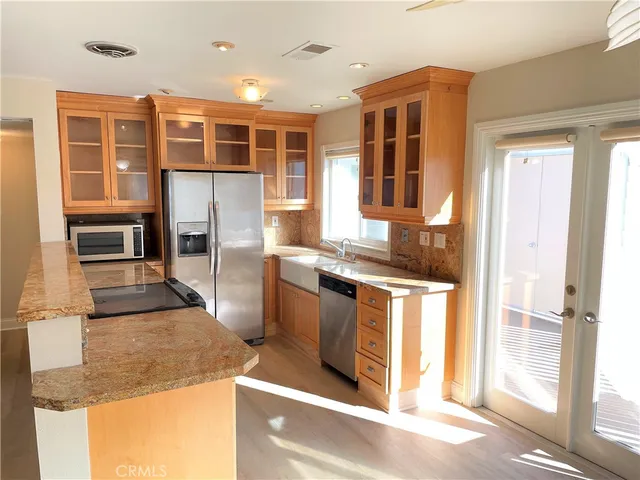 a kitchen with stainless steel appliances granite countertop a stove and a refrigerator