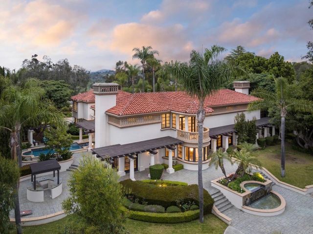 an aerial view of a house with swimming pool and furniture