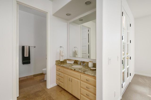 a front view of a house with entryway and a garden