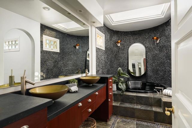 a living room with furniture large window and a fireplace