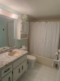 a bathroom with a granite countertop sink a mirror and a toilet