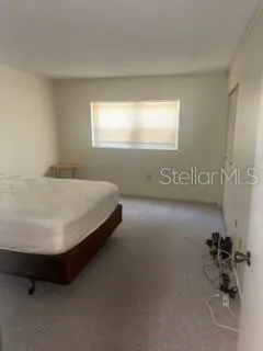 a bed sitting in a bathroom next to a window