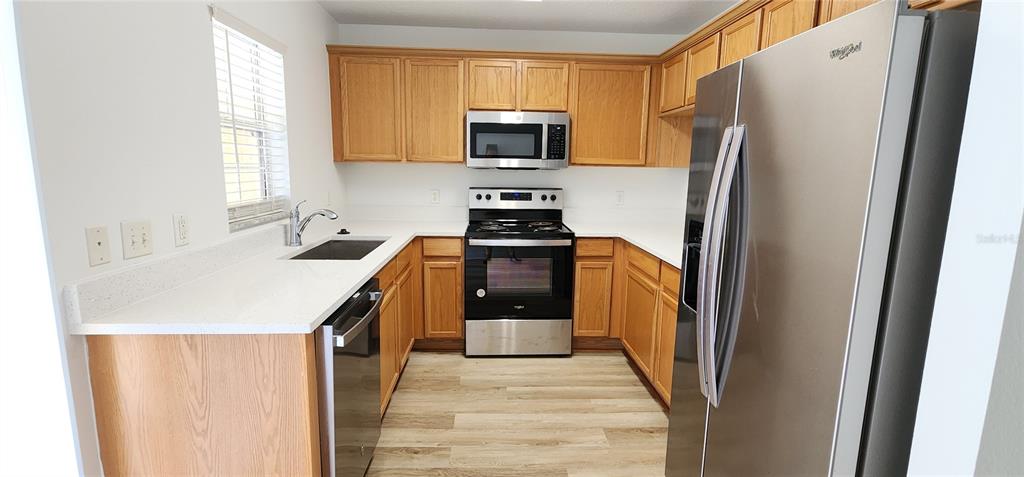 259 Castlekeeper Place Valrico, FL 33594 - Photo 4 of 15 a kitchen with a sink stove and refrigerator
