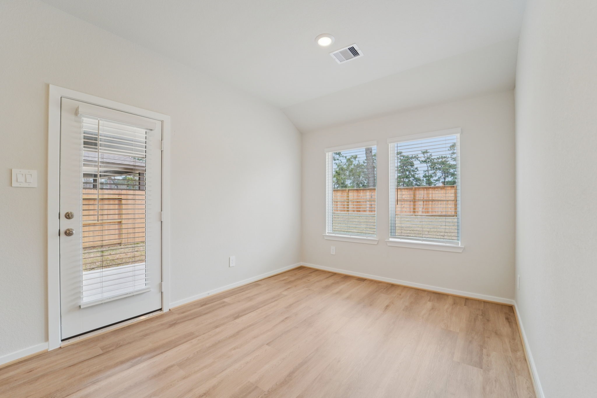 16253 Parish Pointe Court Conroe, TX 77302 - Photo 2 of 15 an empty room with wooden floor and windows
