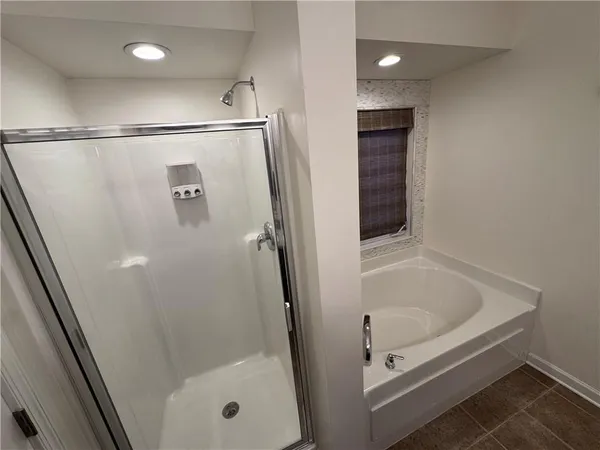 a bathroom with a glass shower door and a sink