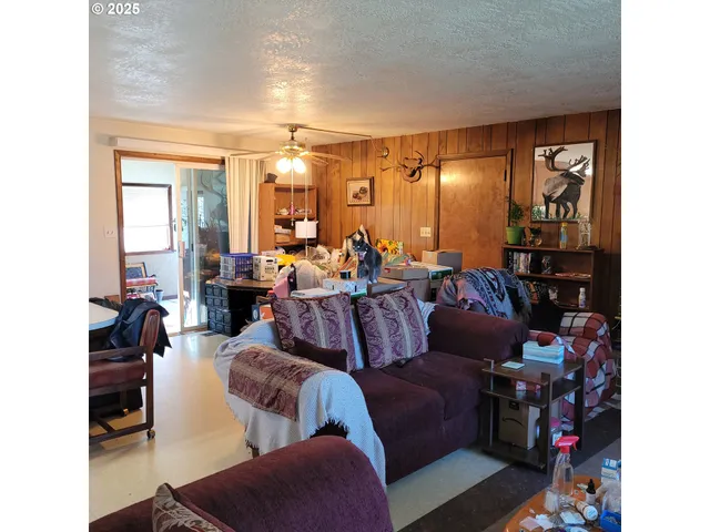 a living room with furniture and large window