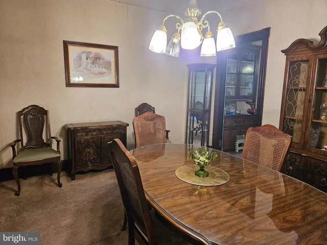 a view of a dining room with furniture and chandelier
