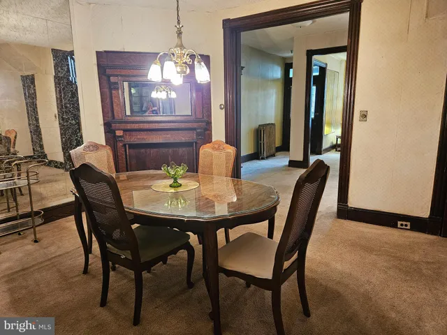a view of a dining room with furniture and a chandelier
