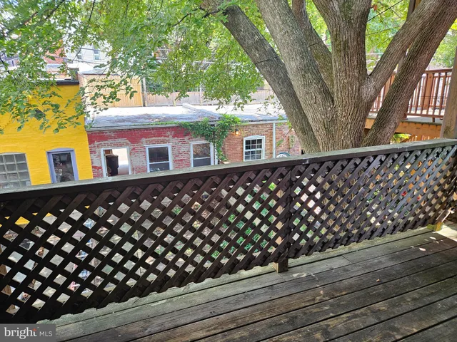 a view of wooden floor and windows in a room