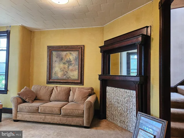 a living room with a couch a dining table and a fireplace