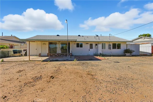 a view of a large white house with a yard
