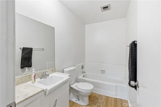 a bathroom with a toilet a sink and bathtub