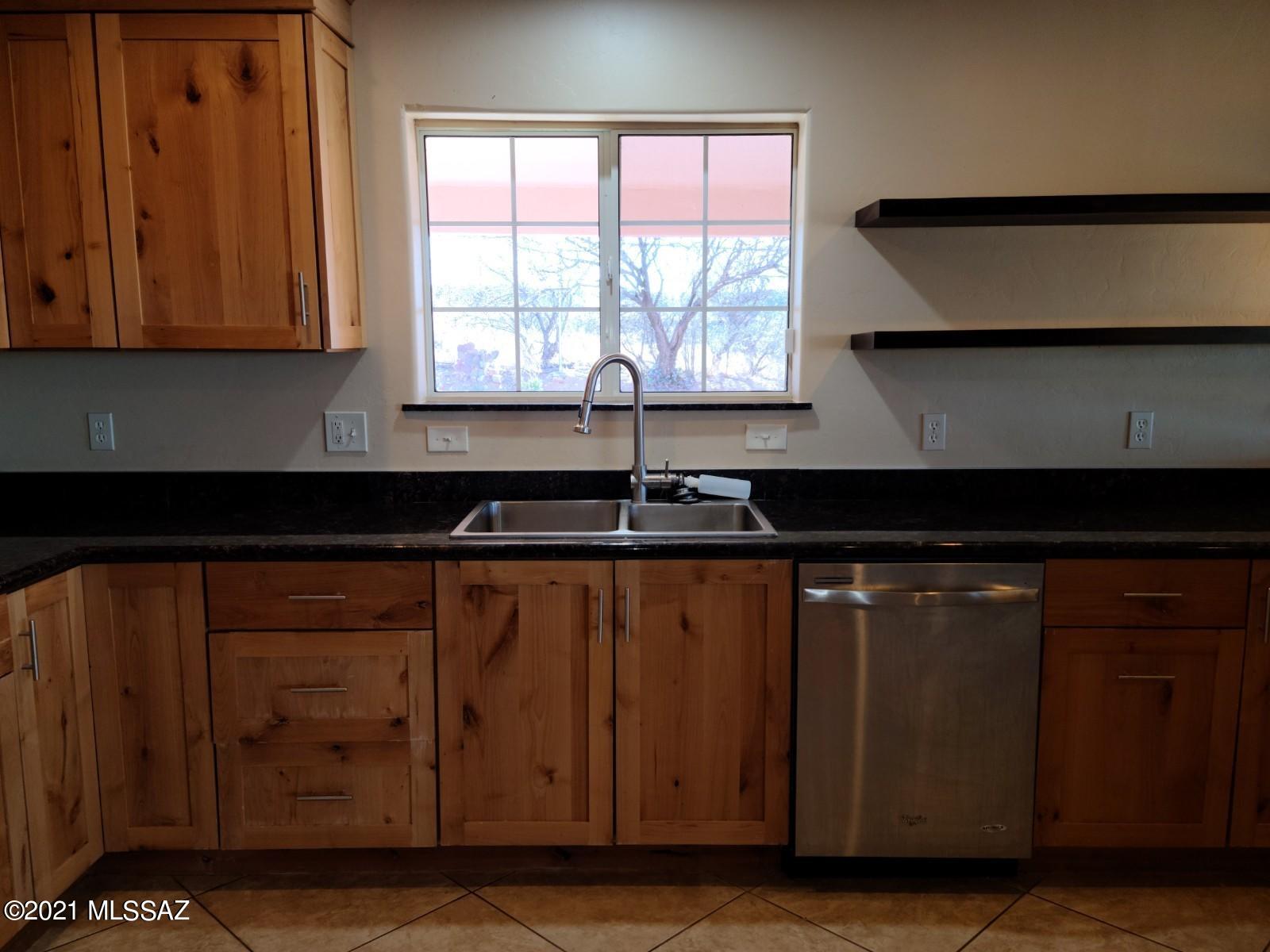 1038 Oso Court Rio Rico, AZ 85648 - Photo 15 of 50 a kitchen with a sink and cabinets
