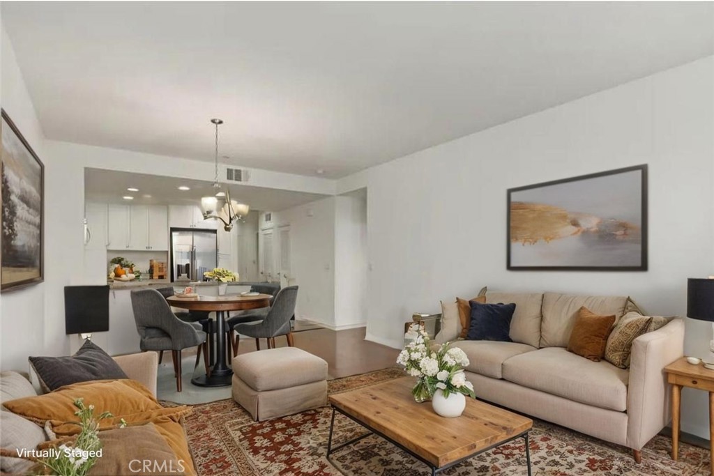 a living room with furniture and a chandelier