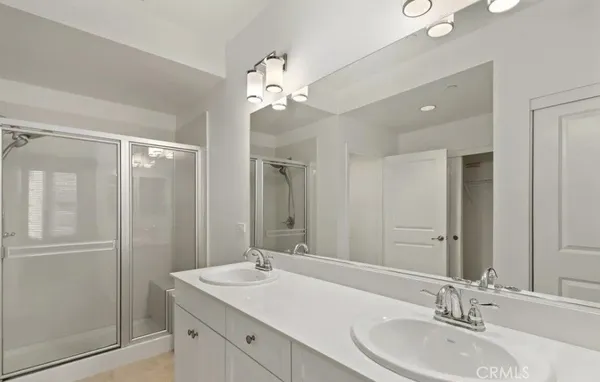 a bathroom with a double vanity sink and a mirror