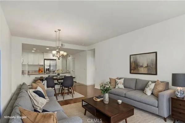a living room with furniture and a chandelier