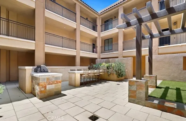 a view of a patio with table and chairs