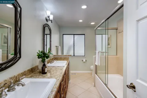 a bathroom with a double vanity sink and a mirror