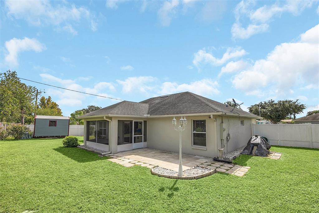 1727 Concert Road Deltona, FL 32738 - Photo 29 of 29 OUTDOOR BACK PATIO AND SCREENED PATIO
