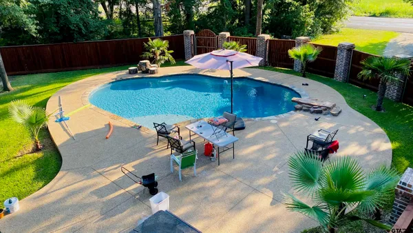 a view of a backyard with sitting area