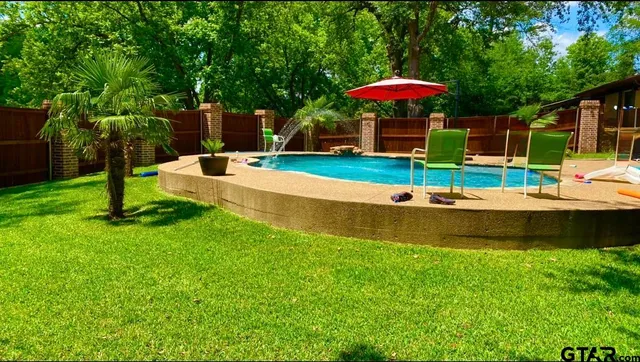 a view of a table and chairs under an umbrella