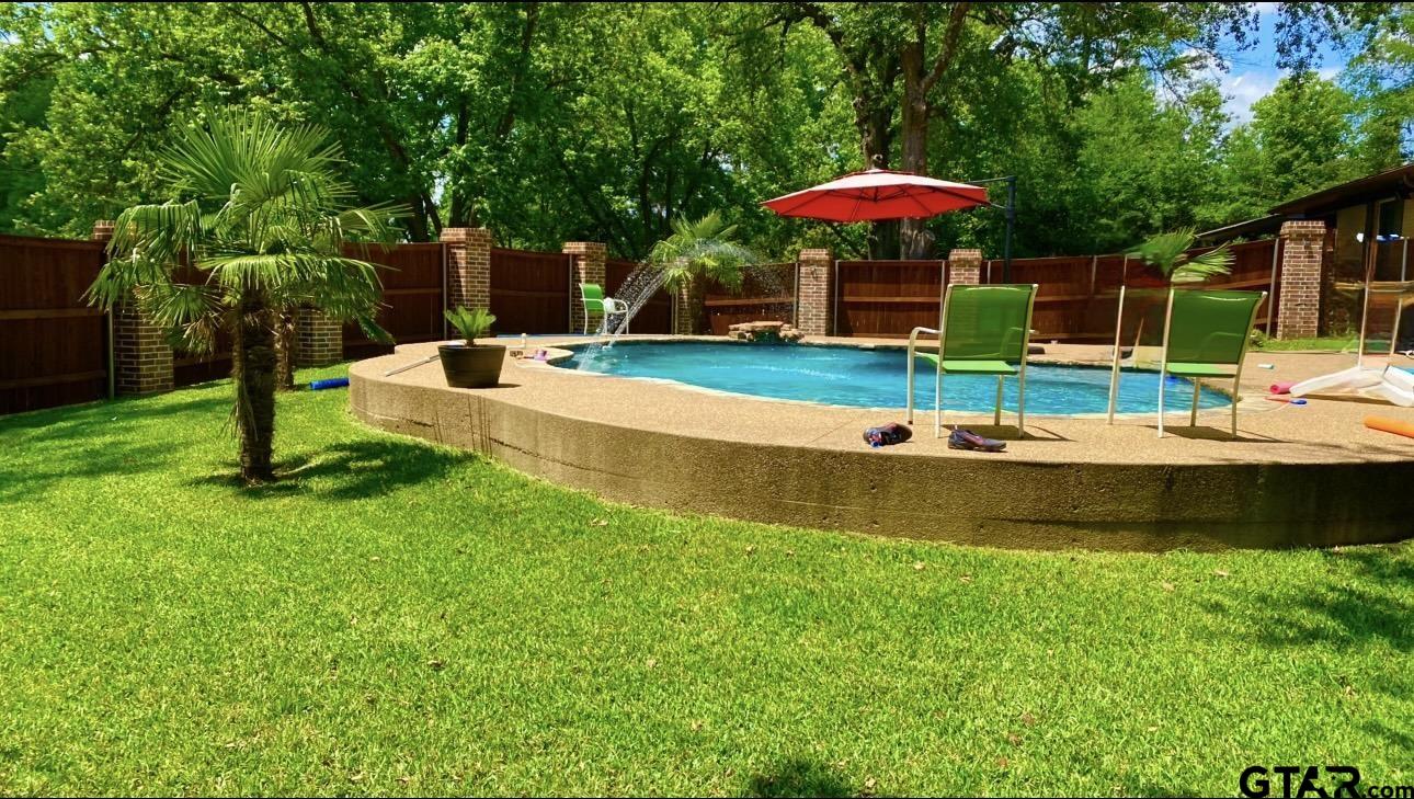 2008 Longview Drive Henderson, TX 75652 - Photo 16 of 27 a view of a table and chairs under an umbrella