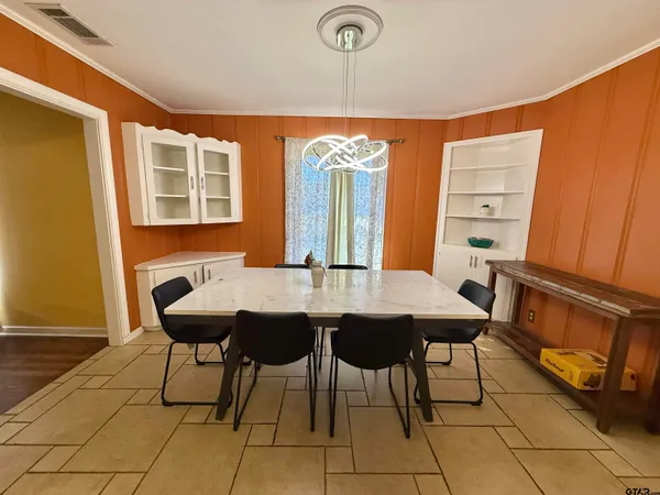 a kitchen with a sink refrigerator and cabinets