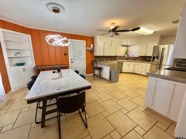 a kitchen with white cabinets stainless steel appliances and a sink