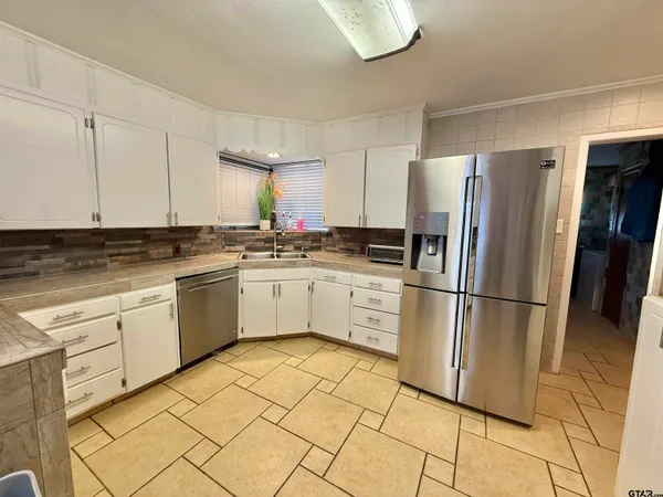 a kitchen with granite countertop a stove and a microwave