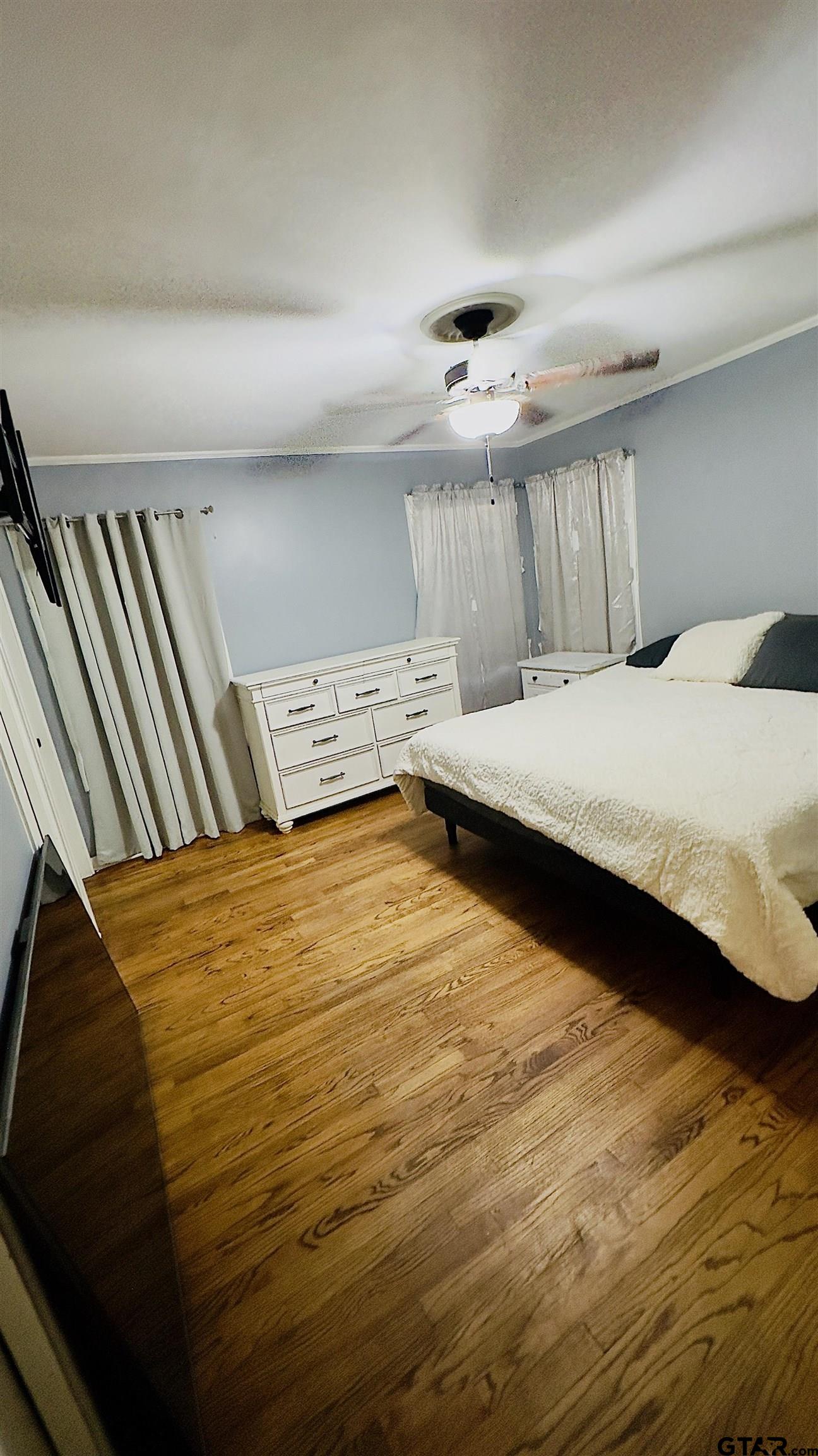 2008 Longview Drive Henderson, TX 75652 - Photo 8 of 18 a bedroom with a bed and wooden floor