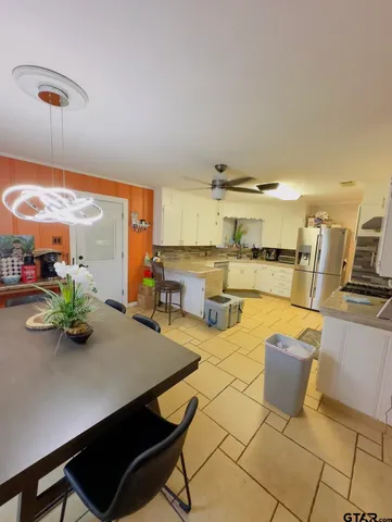 a room with wooden cabinets and dining table