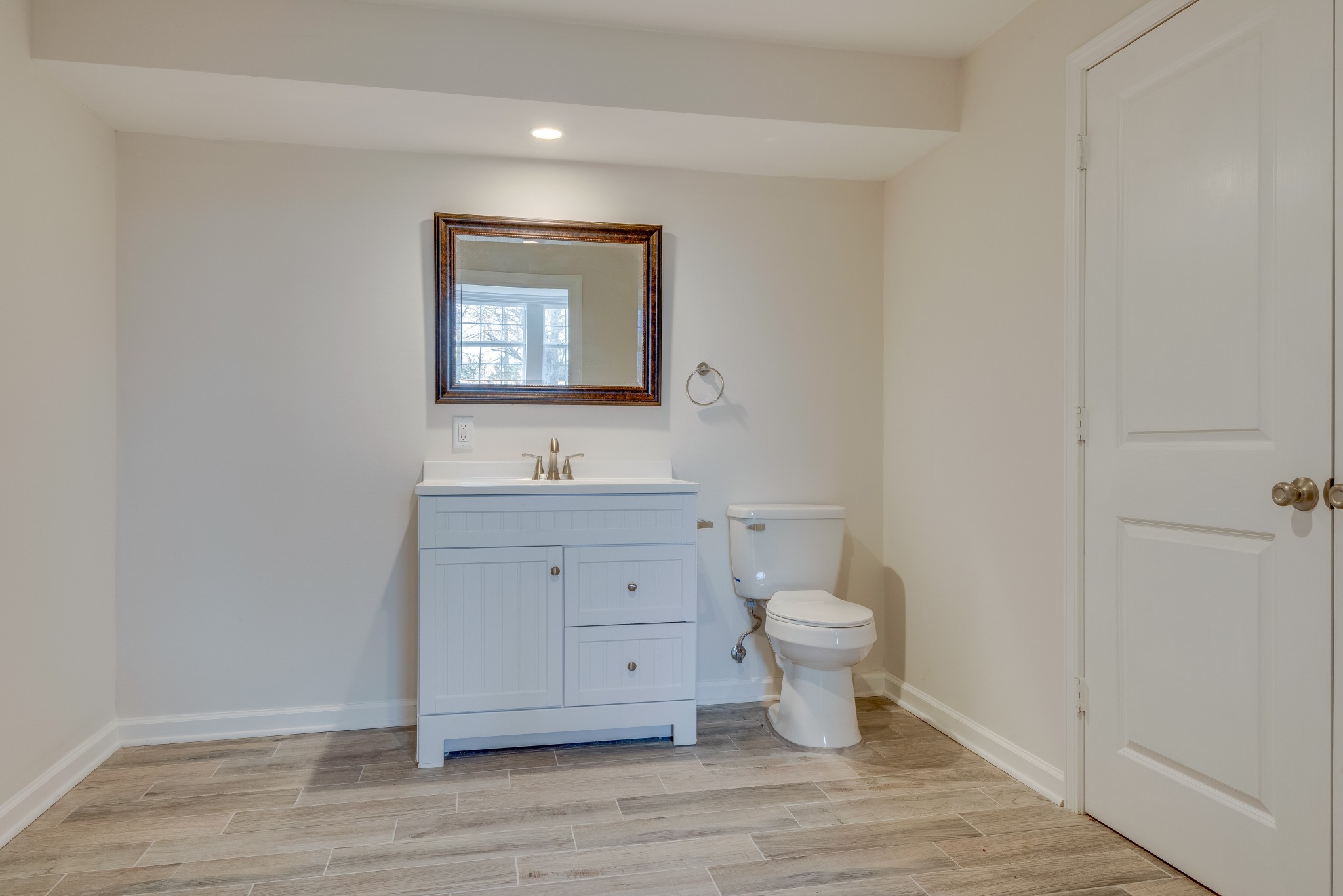 7349 Coldwater Road Fairview, TN 37062 - Photo 20 of 24 a bathroom with a toilet sink and mirror