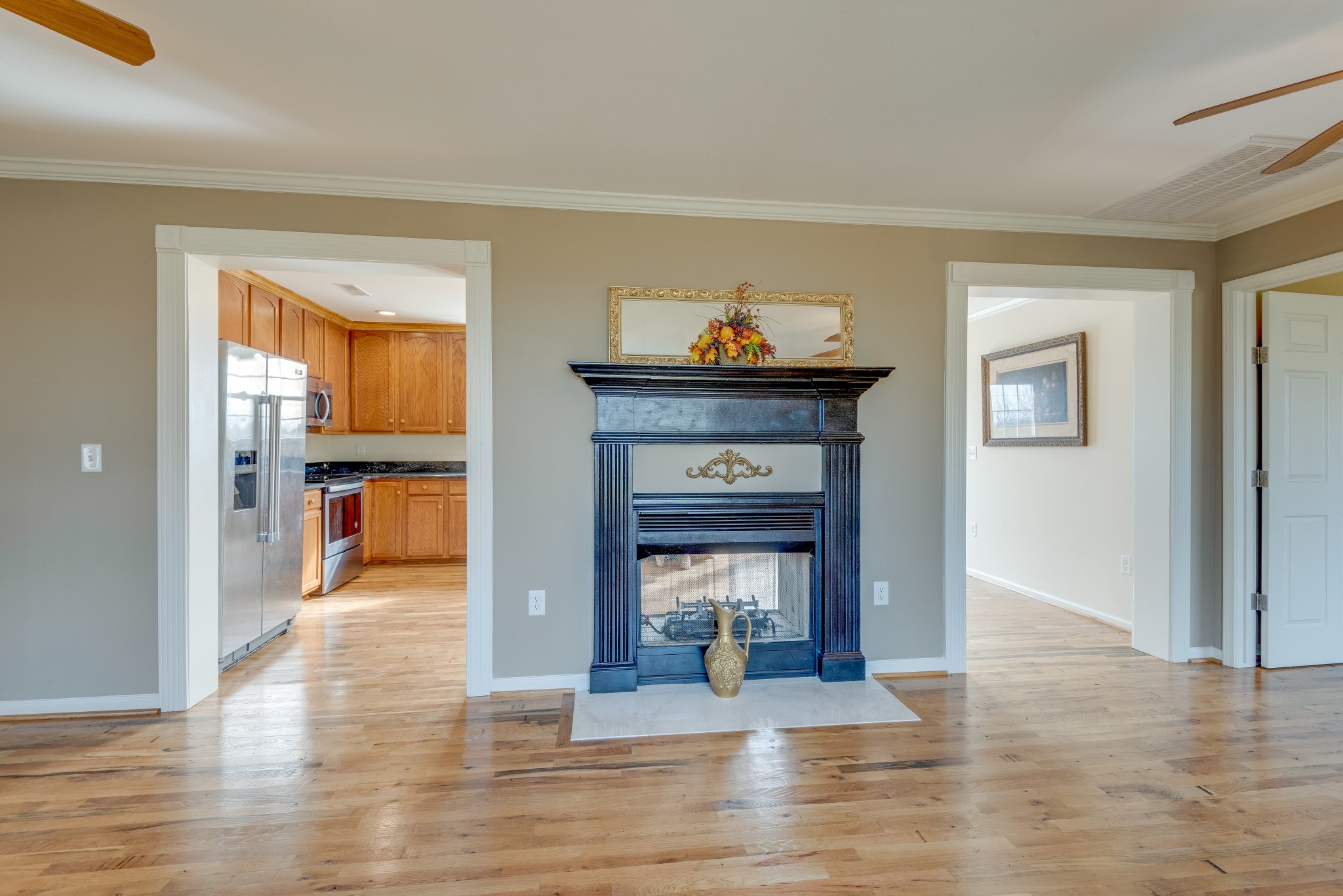 7349 Coldwater Road Fairview, TN 37062 - Photo 5 of 24 a view of a livingroom with wooden floor and a fireplace