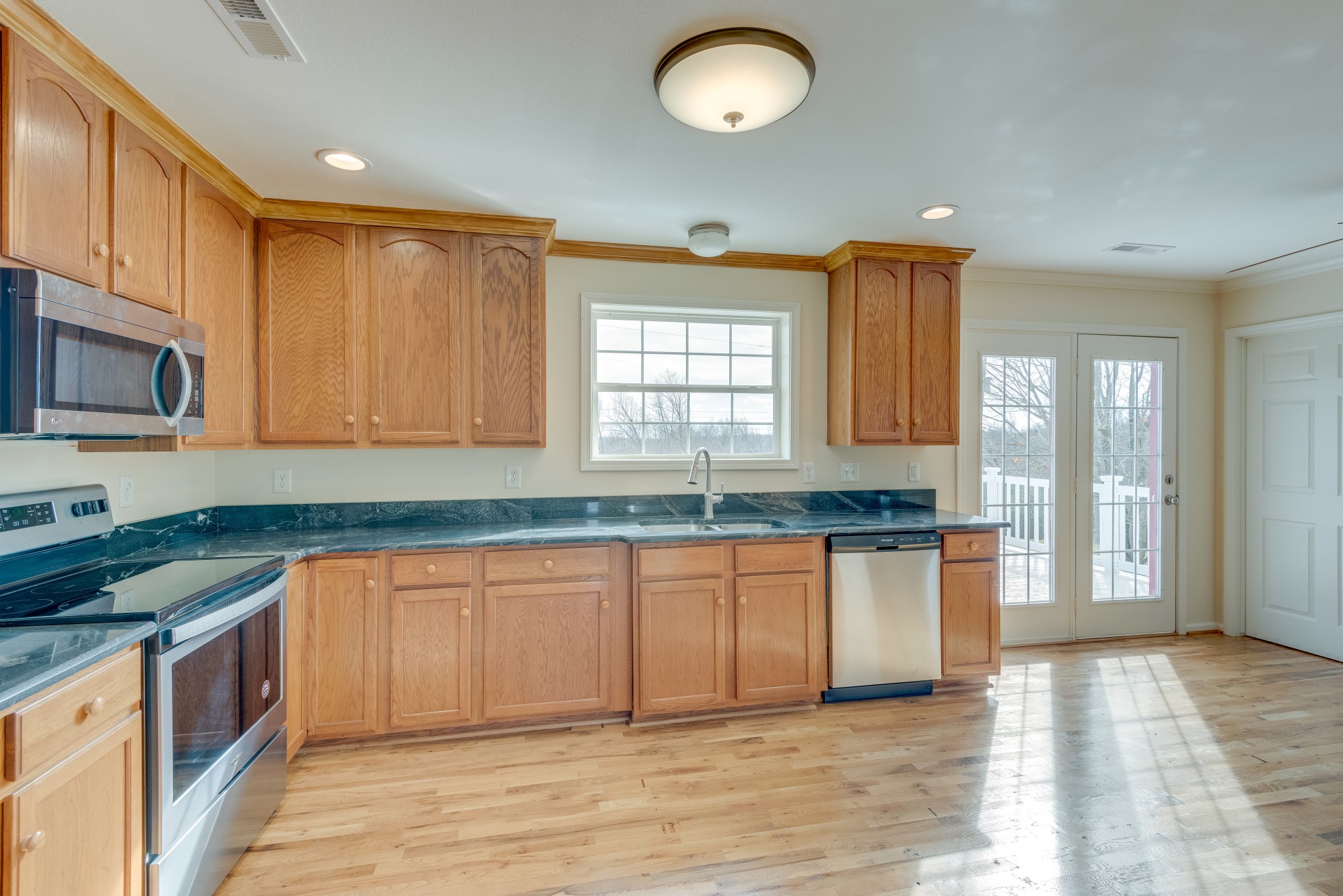 7349 Coldwater Road Fairview, TN 37062 - Photo 8 of 24 a kitchen with stainless steel appliances granite countertop a stove a sink and a microwave