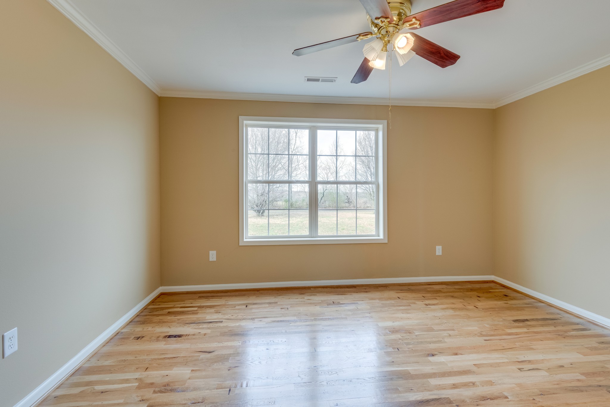 7349 Coldwater Road Fairview, TN 37062 - Photo 10 of 24 an empty room with wooden floor chandelier fan and windows