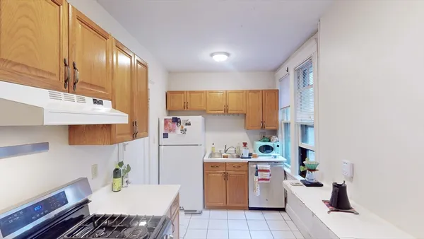 a utility room with cabinets dryer and washer