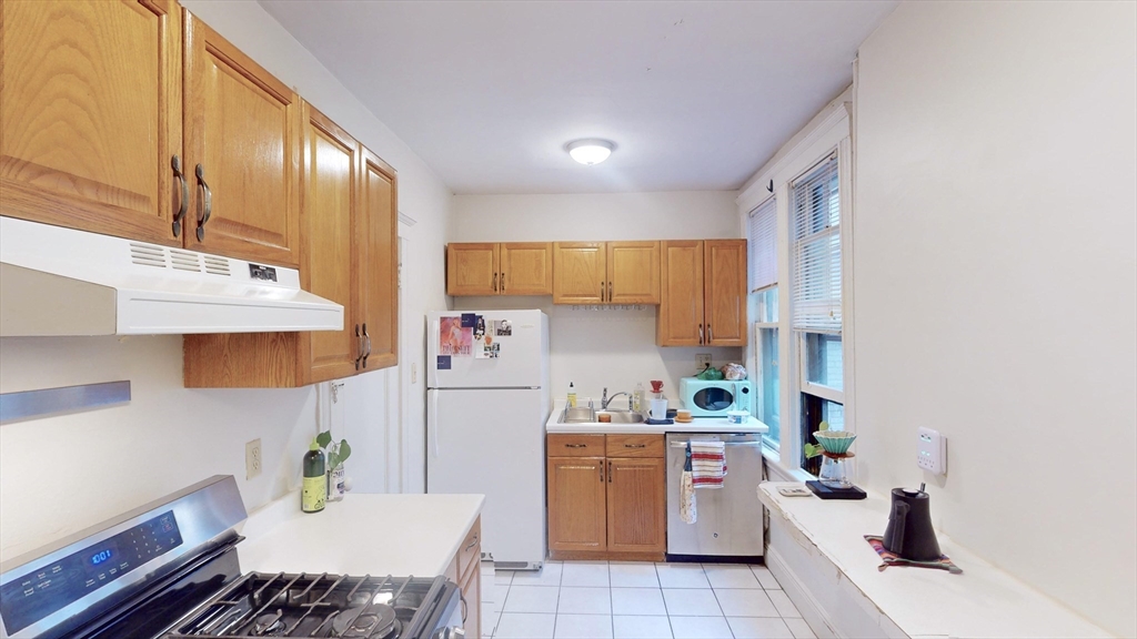 32 Sidlaw Road, Unit 7 Boston, MA 02135 - Photo 1 of 10 a utility room with cabinets dryer and washer