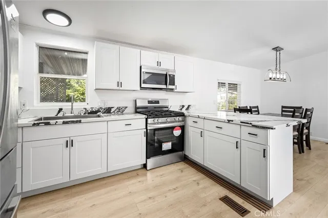 a kitchen with refrigerator and cabinets