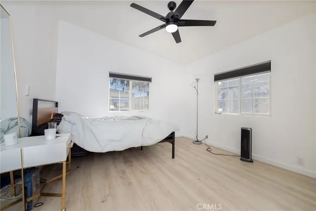 a bedroom that has a bed and a flat screen tv