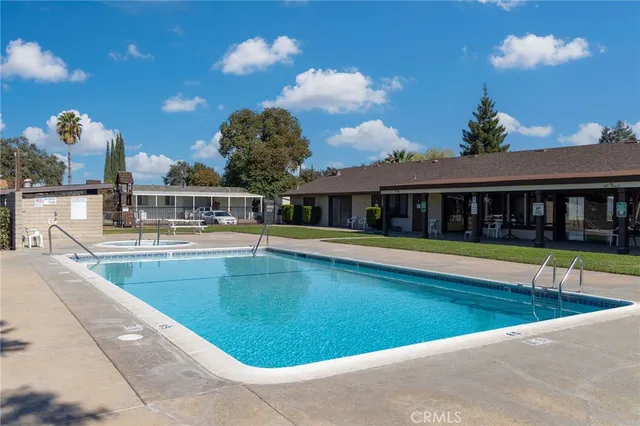 a view of a swimming pool with an outdoor space and seating area